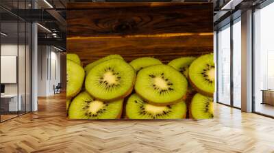 Kiwi fruits on wooden table Wall mural