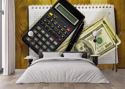 Notebook with fountain pen, banknotes, calculator on a wooden ta Wall mural