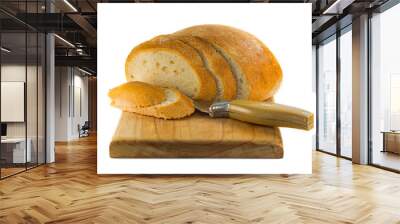 loaf of bread with chopped slices and a knife on a white background. a loaf of round white bread on with a sliced slice and a knife lie on a wooden plate of an isolate on a white background Wall mural