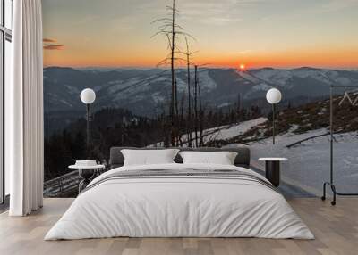 sunrise in the Carpathians on the background of blue mountain ranges and solar disk on the horizon.  Wall mural