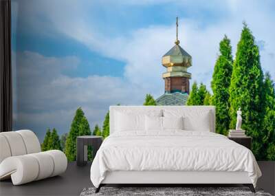 Wooden church with golden domes and place religion of orthodox christian. Built structure for prayer in modern city. Landscape with green park and tower with cross. Ukrainian orthodox church in dnipro Wall mural