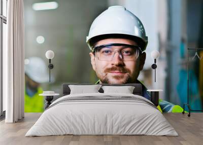 Close up of handsome Caucasian man in helmet on goggles and smiling to camera. Wall mural