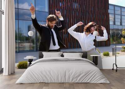 couple of caucasian young stylish businessman in suit and tie and businesswoman in glasses dancing a Wall mural