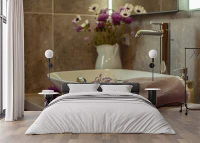 Bathroom interior with bathtub, towel, sink and flowers Wall mural