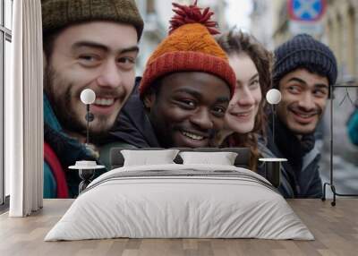 Group of happy young friends having fun in the city. They are smiling and looking at camera. Wall mural