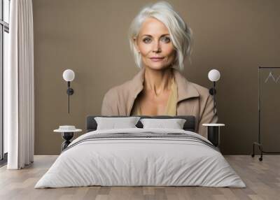 Portrait of a beautiful mature woman with blond hair. Studio shot. Wall mural