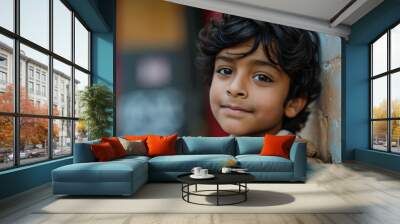 Portrait of a cute indian boy in the street. Selective focus. Wall mural