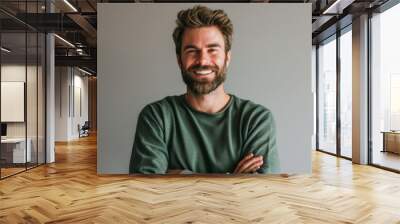 Portrait of a handsome bearded man with crossed arms looking at camera. Wall mural