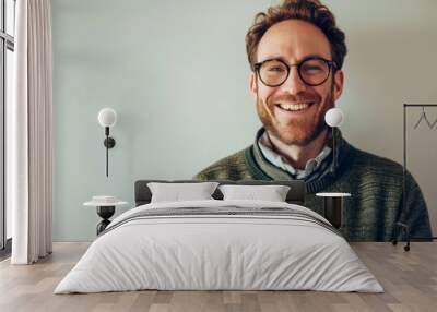 Portrait of a handsome young man wearing glasses and a green sweater Wall mural