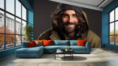 Portrait of a handsome young man with long hair wearing a warm jacket Wall mural