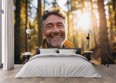 Portrait of a smiling middle-aged man in the autumn forest. Wall mural