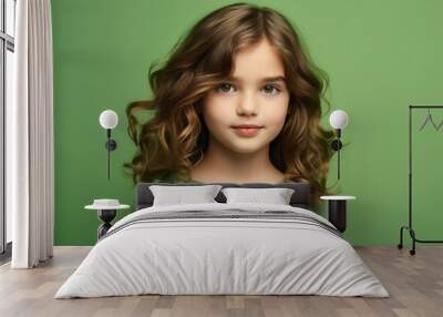 portrait of beautiful little girl with long curly hair on green background Wall mural