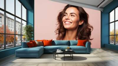 Portrait of happy smiling beautiful young woman, over pink background. Wall mural