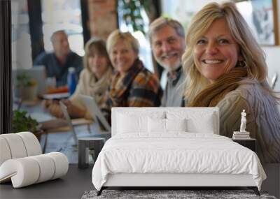 Portrait of smiling businesswoman in office with colleagues in the background Wall mural