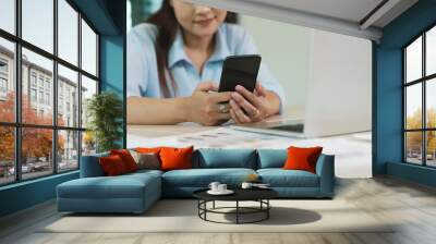 Businesswoman Engaging with Mobile Phone Technology. Digital Entrepreneurship. Wall mural