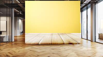 Empty wooden deck table over yellow wallpaper background. Wall mural