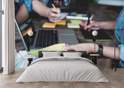 Young photographer and graphic designer at work in studio office. Wall mural