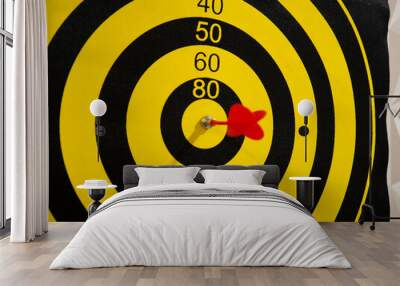 Dartboard with dart arrow in bullseye, close up Wall mural