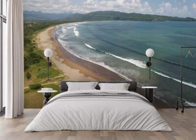 aerial view of tropical beach with green hills.  Wall mural