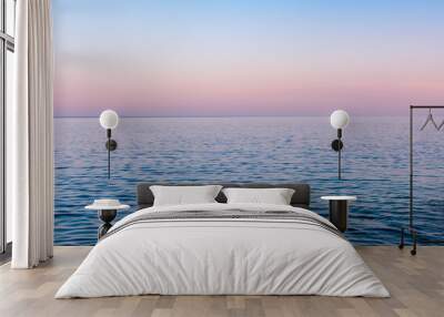 Seascape background, a hazy colorful sunset after a hot summer day over calm sea water, Vis island, Croatia Wall mural