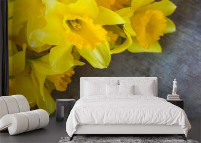 Top view of bright yellow daffodils on old rustic vintage wooden background, spring or easter flower concept Wall mural