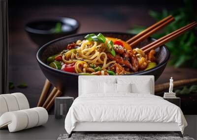 a bowl of food with chopsticks on a table Wall mural