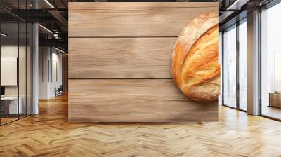 Freshly baked round bread on a rustic wooden table. Wall mural