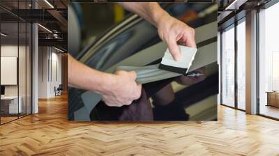 Car wrapper straightening foil with a squeegee Wall mural