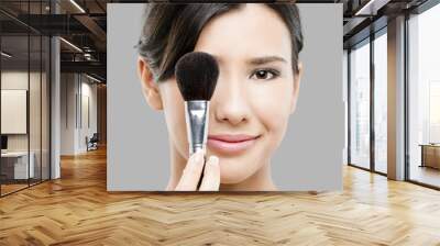 Beautiful Asian woman with make-up brushes Wall mural