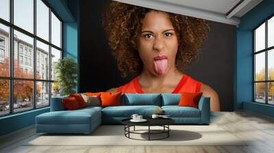 Beautiful woman pulling her tongue out Wall mural