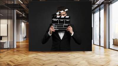 business man holding a clapboard Wall mural