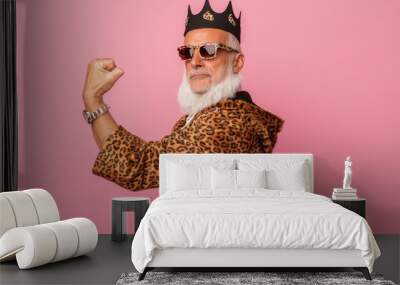 Photo of cool old man winning raise fist wear glamour leopard print outfit isolated pink color background Wall mural