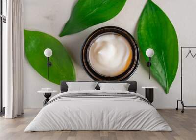 Natural moisturising cream gel in dark glass jar on green leaves as beauty flatlay, spa cosmetics and skincare closeup Wall mural