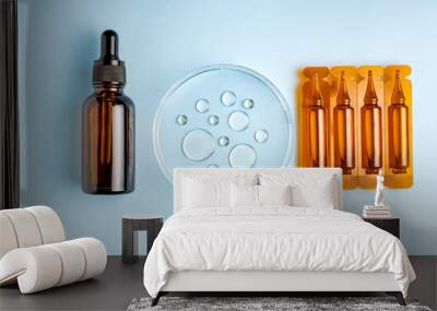 Set of plastic ampoules with dropper bottle and petri dish with drops of oil. Cosmetic laboratory research. Wall mural