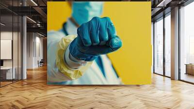 A close up of a doctor in medical gloves making a fist The idea of self isolation during the coronavirus pandemic and the end of quarantine remain at home. Copy space image Wall mural