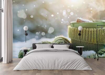 A cozy winter scene with a cup of steaming hot drink nestled in a green sweater outdoors ready for a copy space image Wall mural