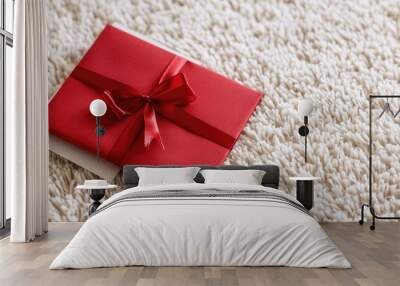 A festive red letter and Christmas gift displayed on a white carpet with ample copy space image Wall mural