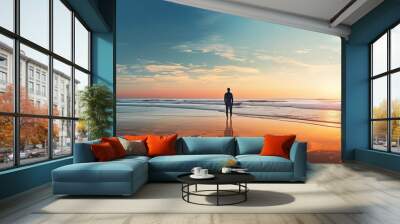 A man standing by the sea and ocean with a copy space image during both sunrise and sunset Wall mural