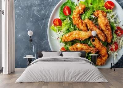 A top-down view of a Chicken Tempura Salad on a white marble plate with deep-fried chicken strips, lettuce salad mix, and cherry tomatoes on a stone anthracite background with text copy space image. Wall mural