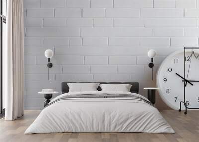 A white clock is hanging on a white brick wall creating a simple design and decoration for the background. Copy space image. Place for adding text and design Wall mural