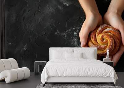 Bakery black backdrop with a roll and female hands flat lay top view copyspace banner Wall mural