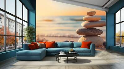 Balanced rock pyramid on pebbled beach with golden sea bokeh Zen stones on sea beach conveying meditation spa harmony and balance Copy space image Place for adding text or design Wall mural