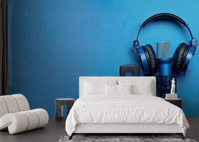 Banner layout featuring accessories for recording and listening to sound headphones voice recorders microphone and cables on a blue background viewed from above The concept focuses on capturing pure Wall mural