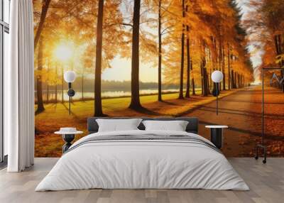 Beautiful autumn day featuring colorful trees with golden leaves set in a panoramic landscape on a meadow with a real sun, creating an idyllic scene with copy space image. Wall mural