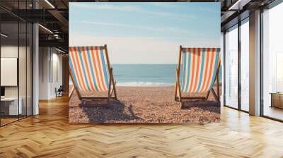 Brighton s pebble beach showing empty striped deckchairs with ample copy space image Wall mural