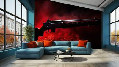 Close up image of a rifle gun designed for hunting with air pellets breaking in two on a dark cloth background illuminated by a red light offering ample copy space Wall mural