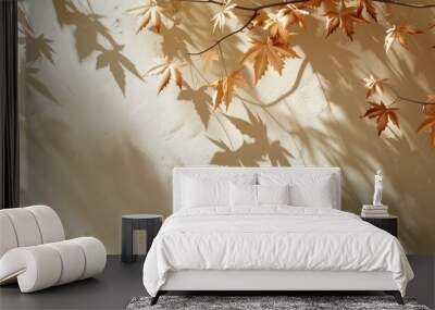 Cream colored abstract autumn scene with maple tree leaves shadows on a wall background ideal for copy space image Wall mural