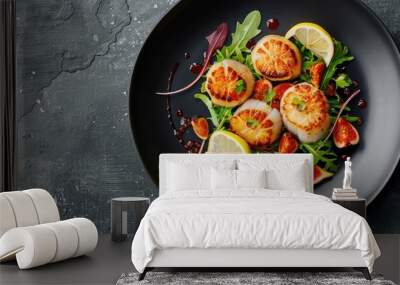 Fried scallops accompanied by lemon figs sauce and green salad presented on a black plate against a gray textured background Top view copy space Plating fine dining Wall mural