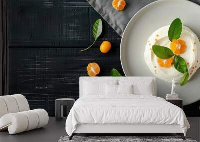 Greek yogurt with kumquat pieces displayed on a white plate against a black wooden background top view flat lay copy space Wall mural