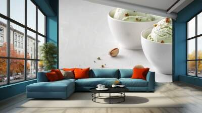 Homemade pistachio ice cream topped with nuts in white bowls on a white kitchen table copy space Summer refreshing desserts Wall mural